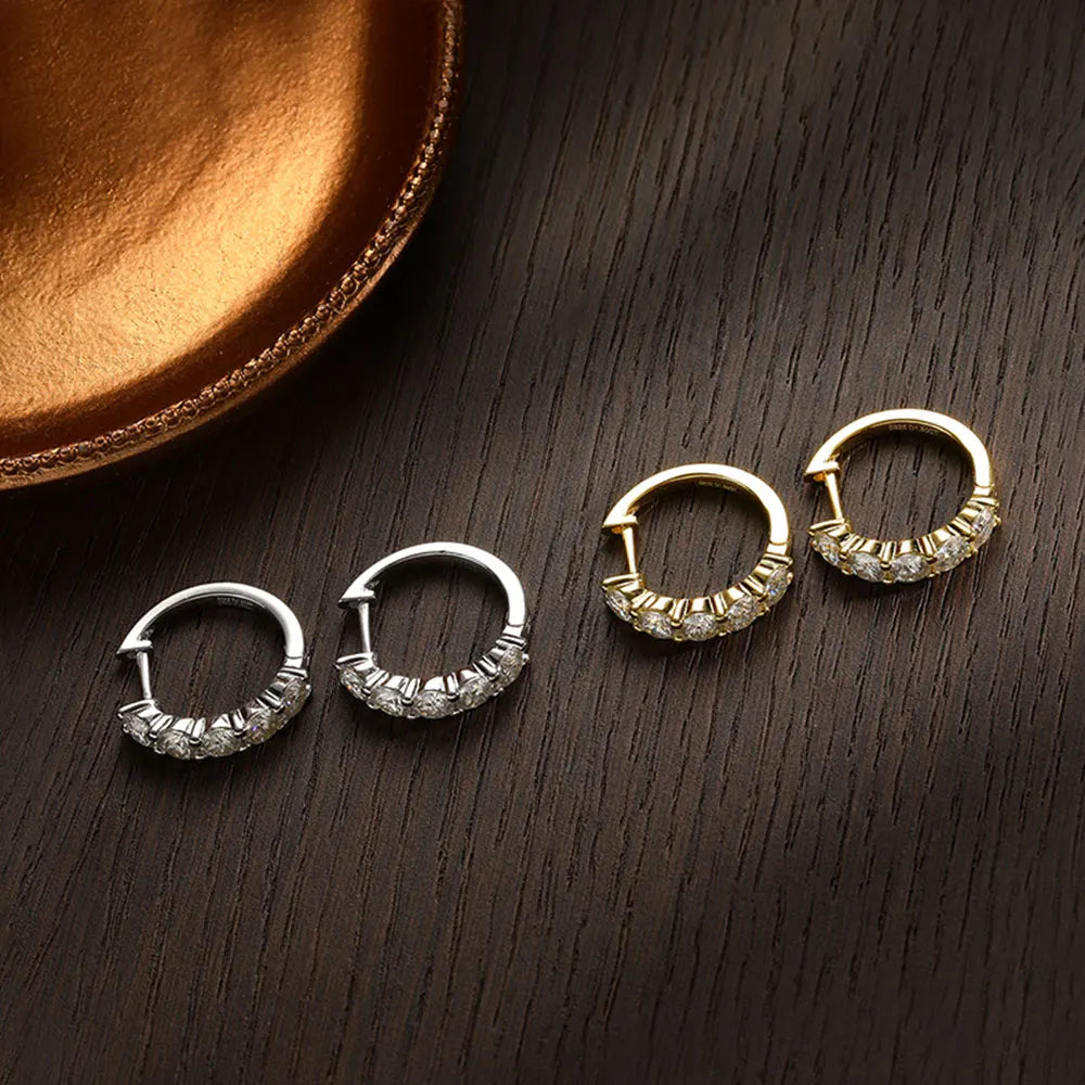 Pair of silver and gold moissanite stud earrings designed as minimalist hoops moissanite for a timeless look