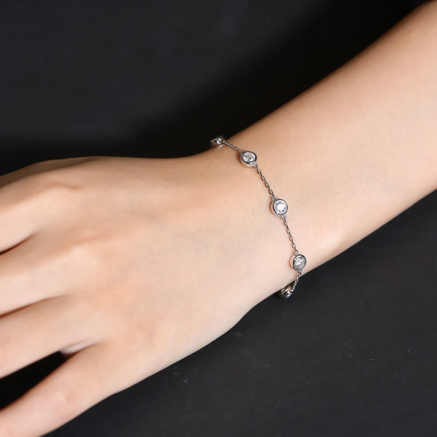 Woman wearing silver gra moissanite bracelet