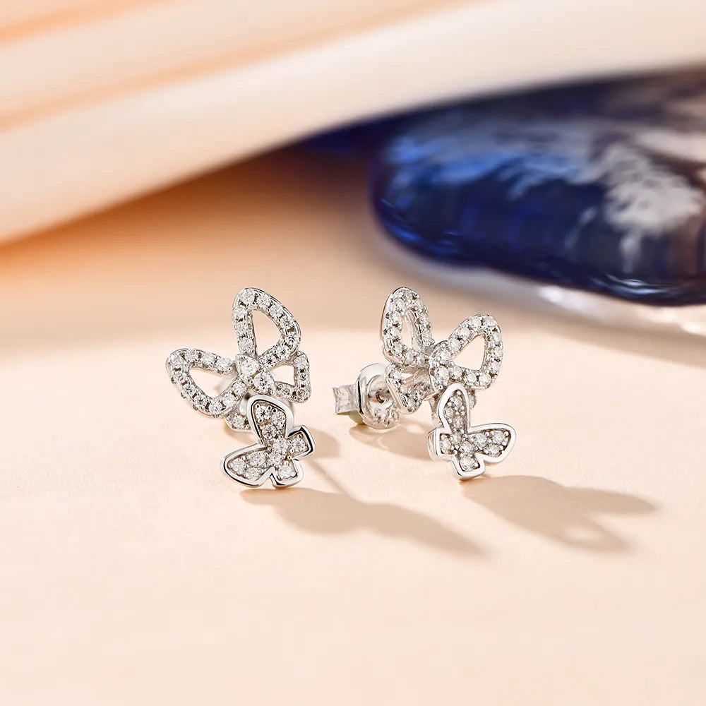 Chic silver moissanite earrings adorned with small, dazzling moissanite stones.