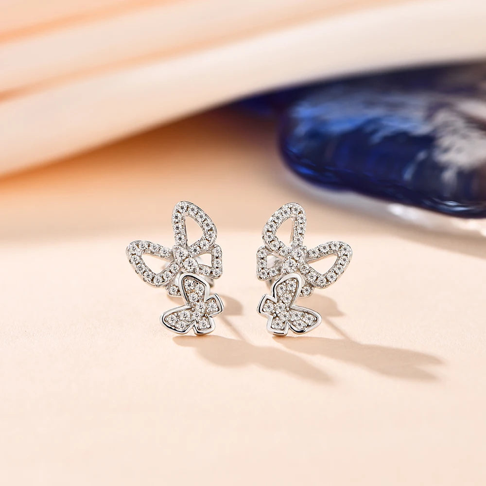 Stunning silver moissanite earrings with intricate leaf designs and tiny sparkling stones.