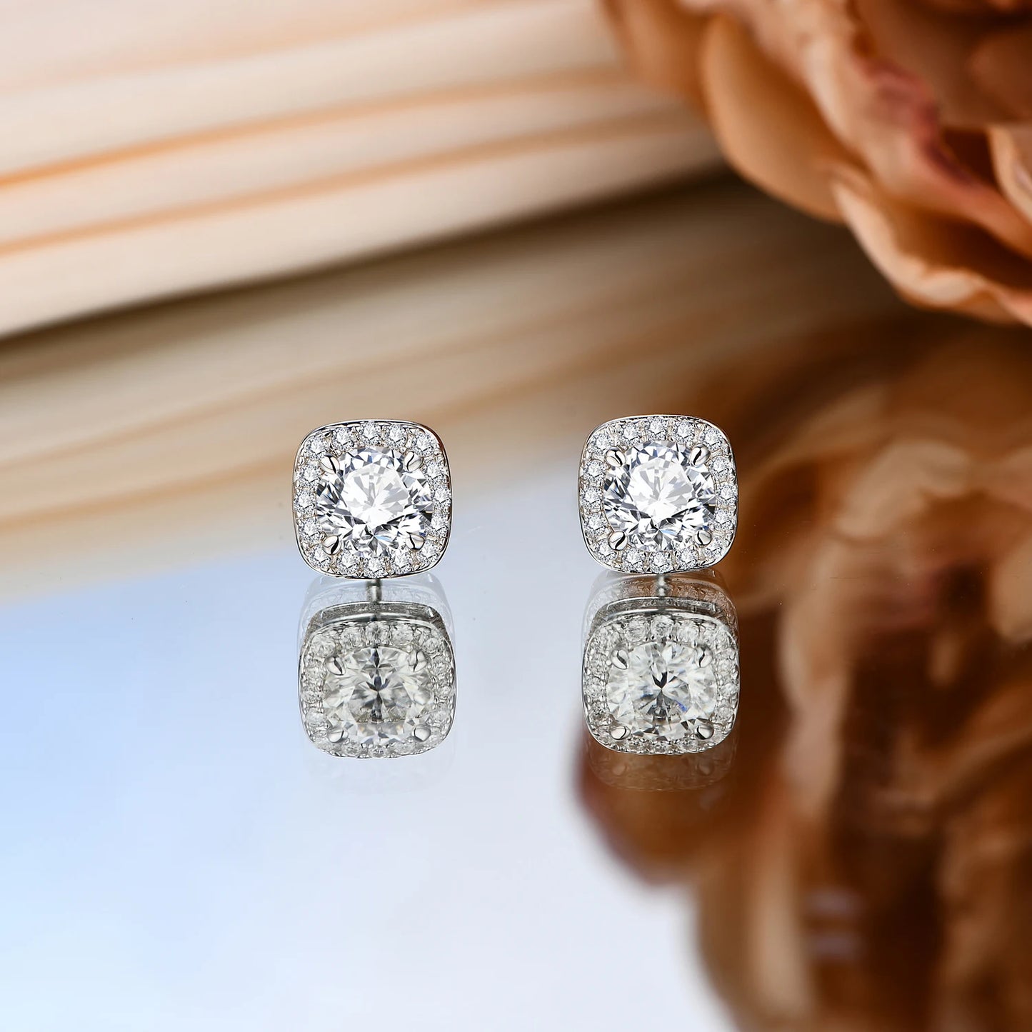 luxurious gold moissanite stud earrings featuring a dazzling central stone and a halo of brilliance.
