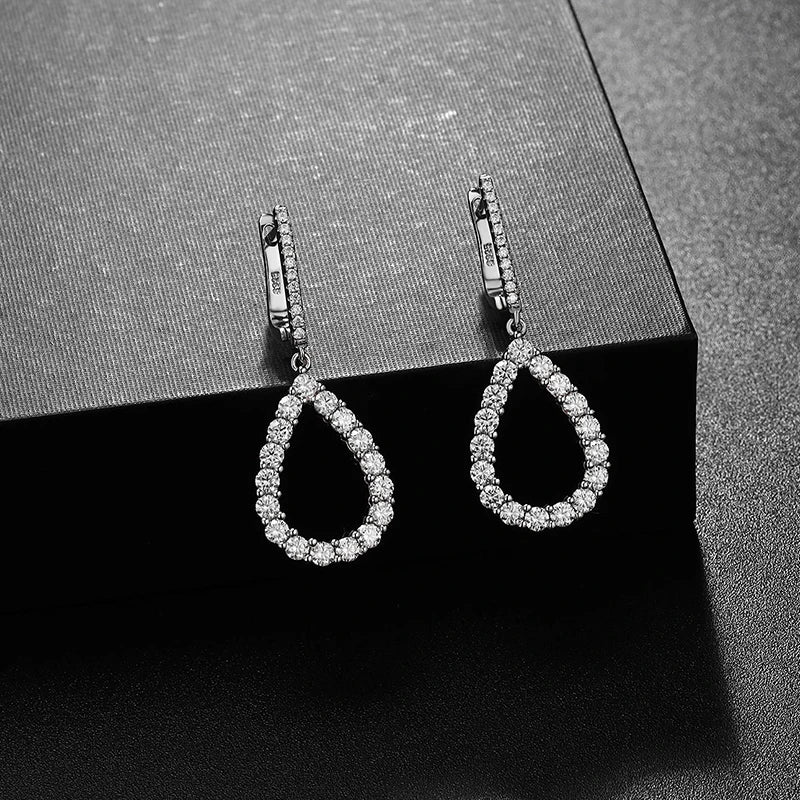 silver moissanite stud earrings transformed into drop earrings with multi small moissanite stones gram moissanite for a luxurious finish