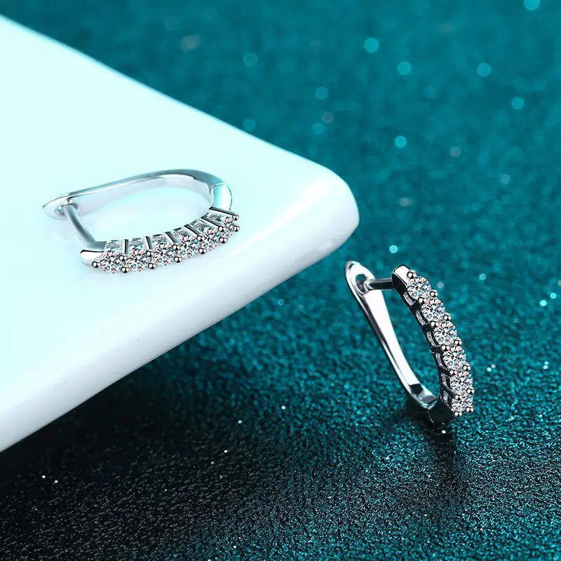 Timeless gold moissanite clip earrings with a radiant center stone.